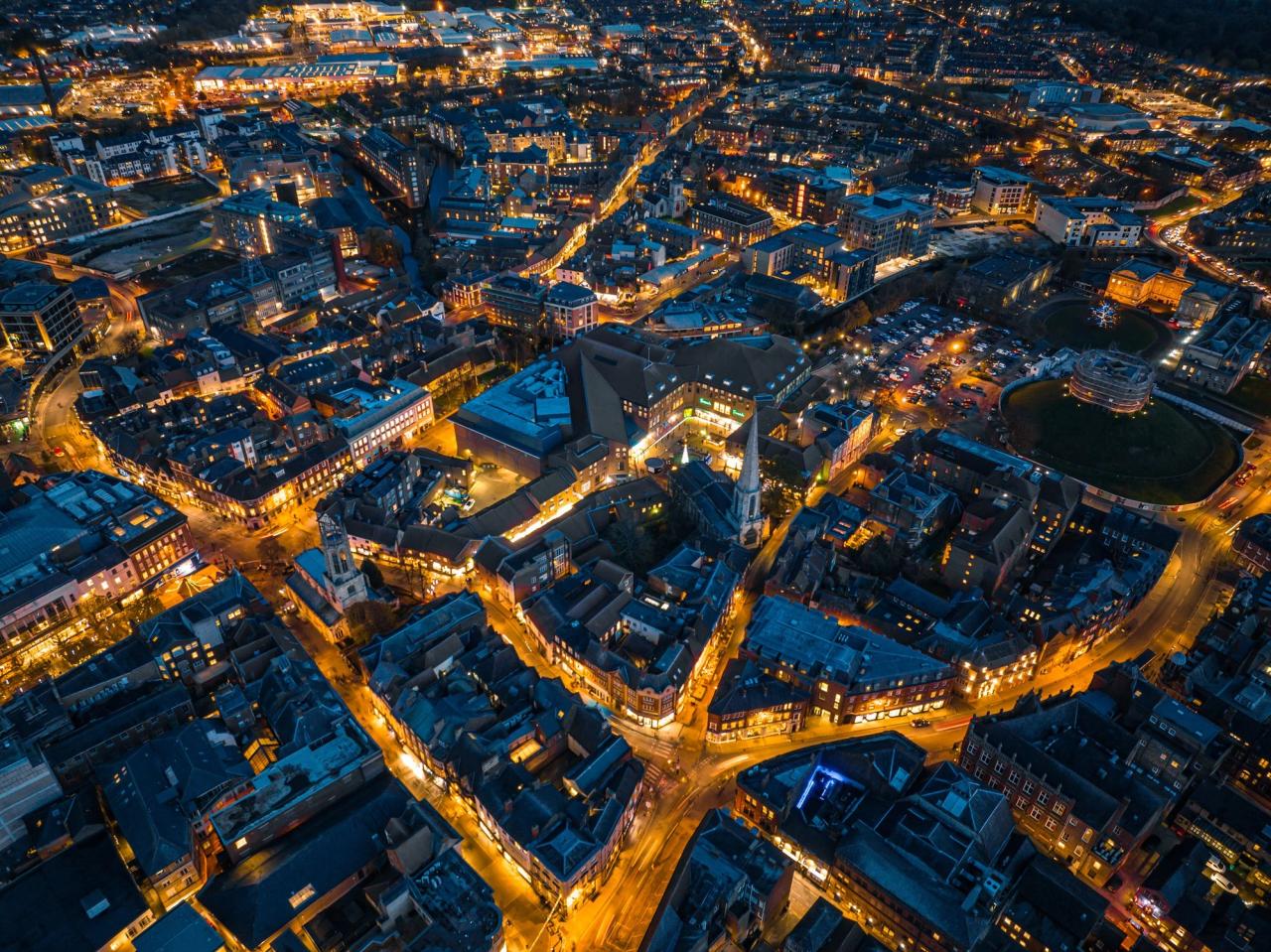 Aerial view of city at night with light up streets