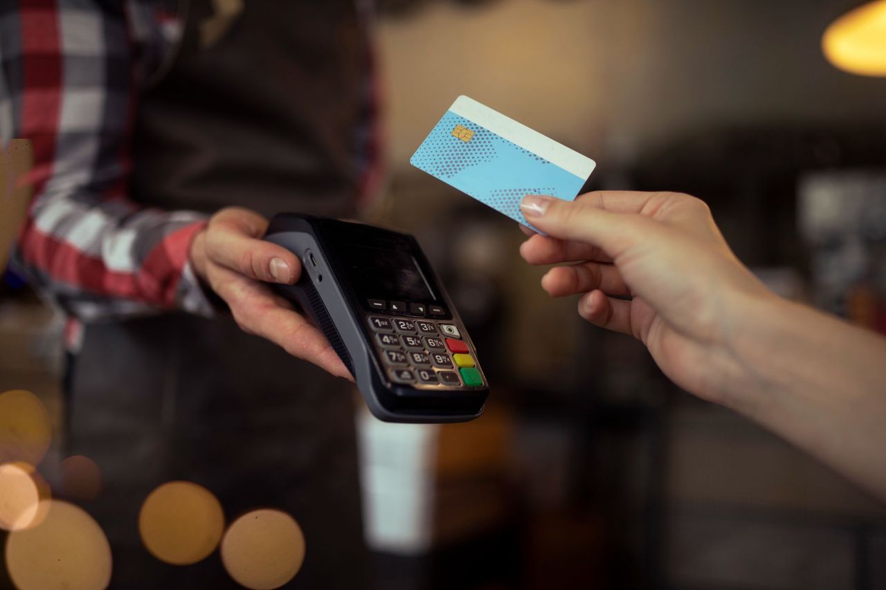 Someone paying with a bank card at a POS terminal
