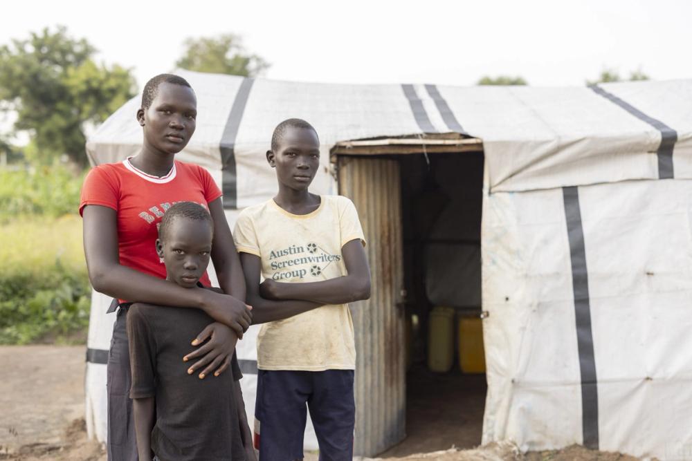 Mary with her brothers, David* and John*, at the Palorinya Refugee Settlement in northern Uganda.