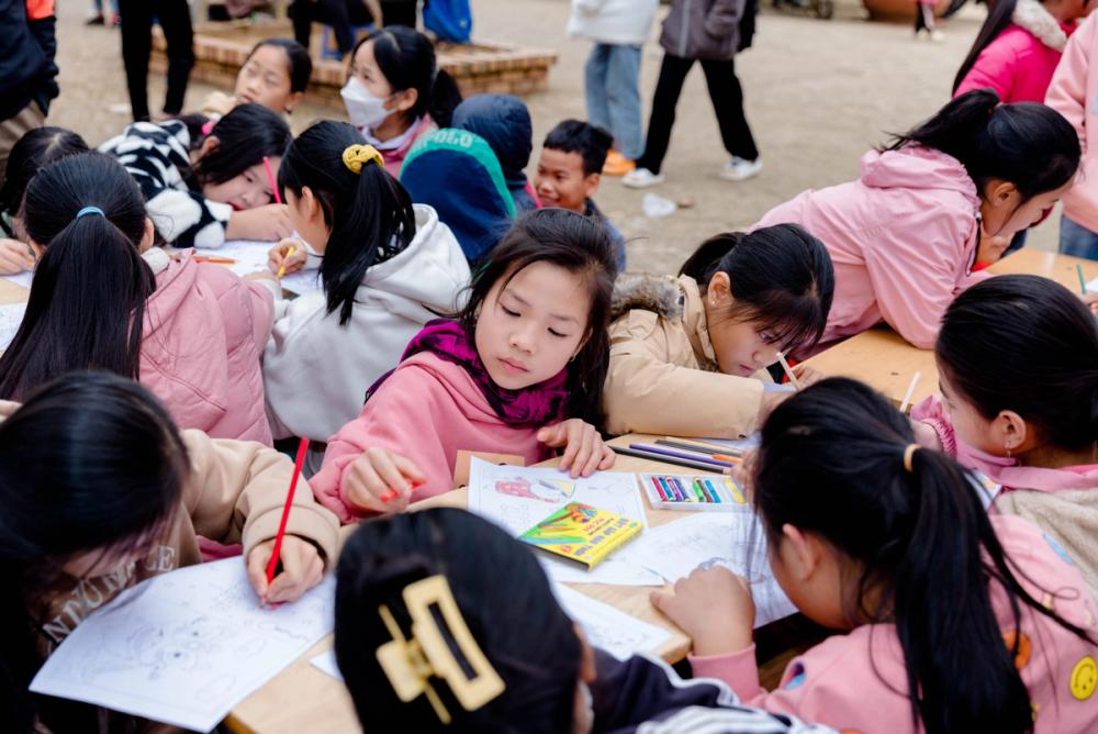 Primary and preschoolers students take part in a colouring session together in Vietnam.