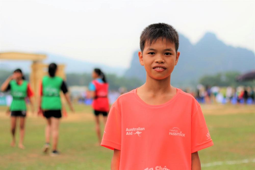 Vietnamese boy in red shirt smiling 