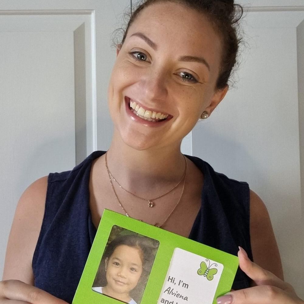 Carla with a photo of her sponsored child. Carla sponsored children through ChildFund Australia for six years before joining the organisation as an employee in 2021. “Being involved with a charity and giving back has opened my eyes."