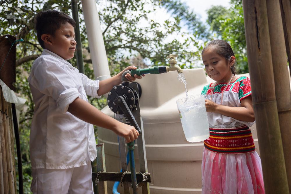 María (right) and her brother now have clean drinking water on tap.