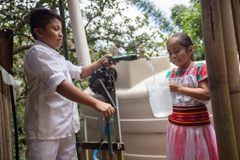 María (right) and her brother now have clean drinking water on tap.