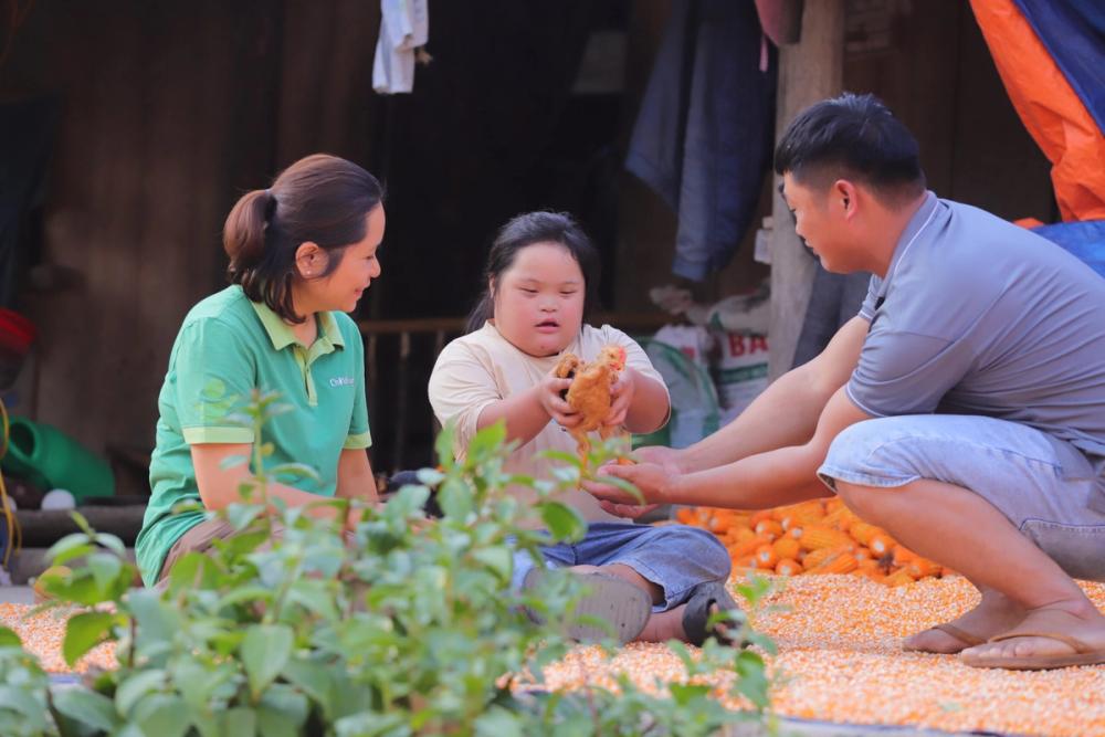 Hao (centre) and her father, Hung (left) with their new chickens.