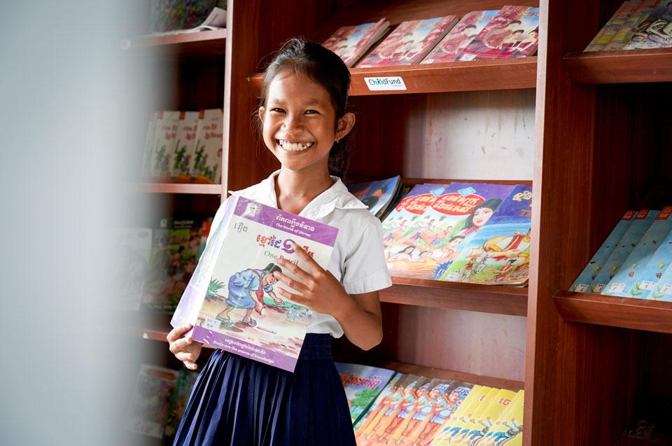 Rasmei (10) loves to read in her school library. 