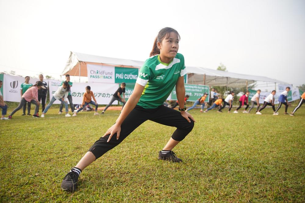 Girl warming up before rugby game