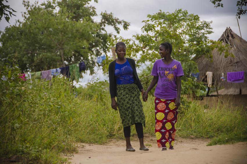 Sixteen-year-old Carol, left, walks and talks with her mother, Mavis, 29. Says Mavis, "Carol is committed to school. She does not fool around, and I teach her about the way a young lady should conduct herself. Carol aspires to become a teacher so she can take care of her parents.