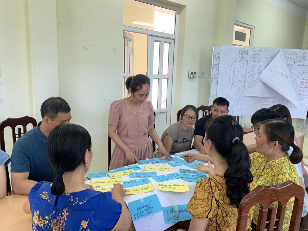 Ms. Sam (centre) leading a group discussion in a training session on Sexual Reproductive Health for teachers in Tan Lac district, Hoa Binh province, Vietnam. She puts what she has learnt into practice, below.