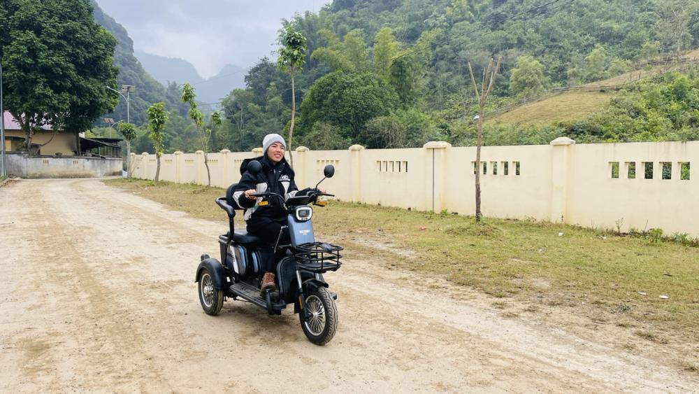 Ngoc rides her three-wheeled electric scooter around her rural village in Cao Bang province. She purchased the scooter with money raised from raising and selling animals.