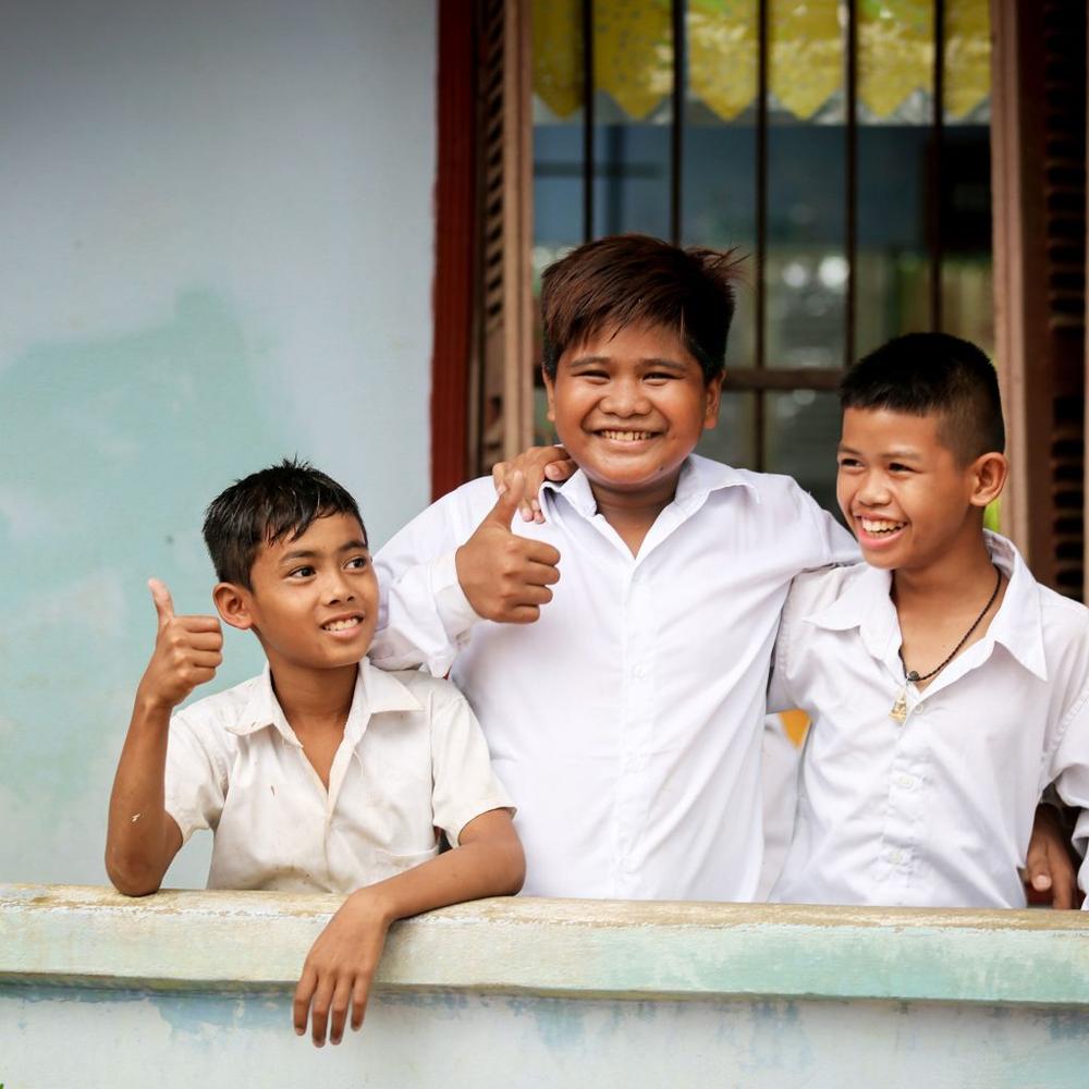 Happier days: After missing out of an education for many years, Prasak (pictured above, in the middle, with his friends) is back studying and determined to finish high school. “I want to have a better job and a better future than my parents,” Prasak said.