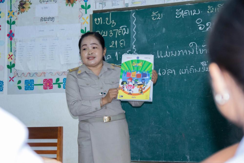 Khambang (pictured above), a teacher in rural Laos, says students have reacted positively to the school's new financial literacy program, "Cha-Ching".