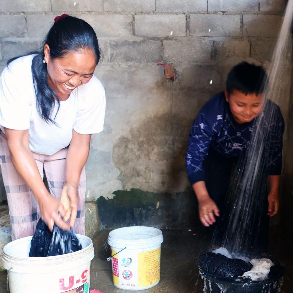 ChildFund in Laos and local partners helped to install a clean water system in Kankham's village in 2022. Kankham and his mother Khonejai (pictured above) can now access clean water from the comfort and safety of their own home.