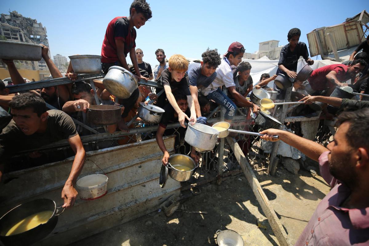 Starving children in Gaza waiting for food distribution