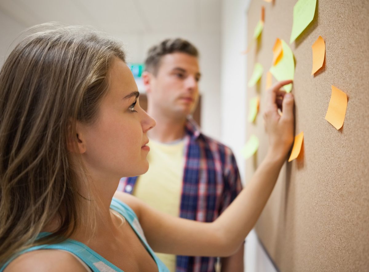 Two Scrum team members discuss the backlog. What is Scrum? It's structured collaboration.