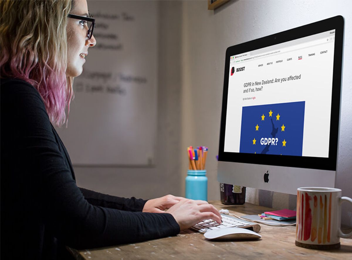 A woman reading about the GDPR in New Zealand on the Boost blog.