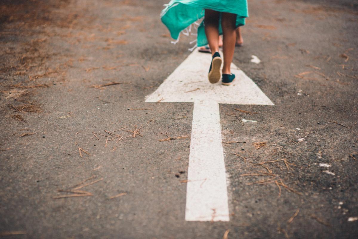 People following an arrow painted on the road. The Product Vision paints the way ahead for the project.