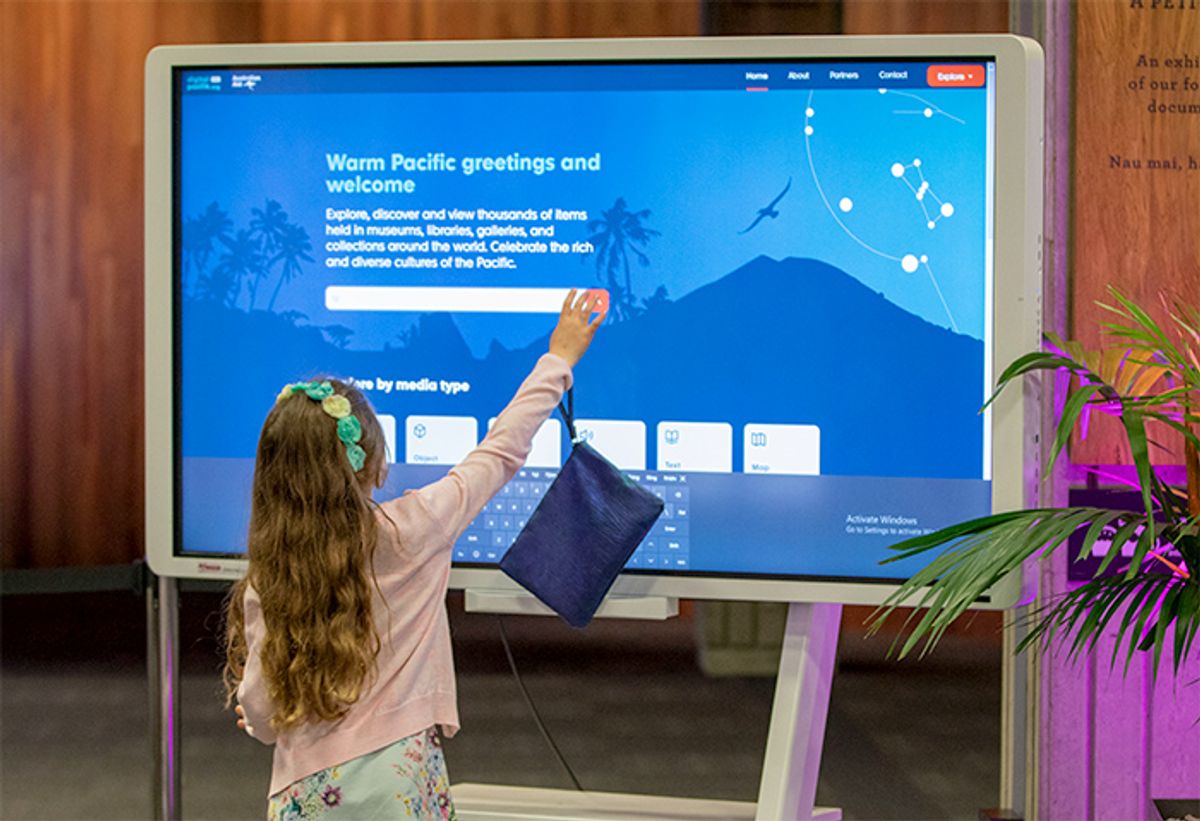 A girl using digitalpasifik.org on a giant touch screen at the launch. This co-design case study shows how the project delivered this end result.