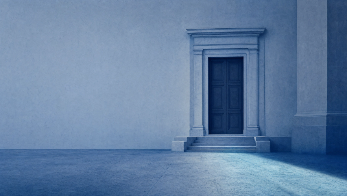A wide, calm civic threshold seen at distance: a single set of tall, plain doors set into a quiet institutional facade in muted ink-navy, with a soft diagonal current of pale blue-tinted light flowing toward the doors from the right. No people, no text. The mood is considered and quietly under load.