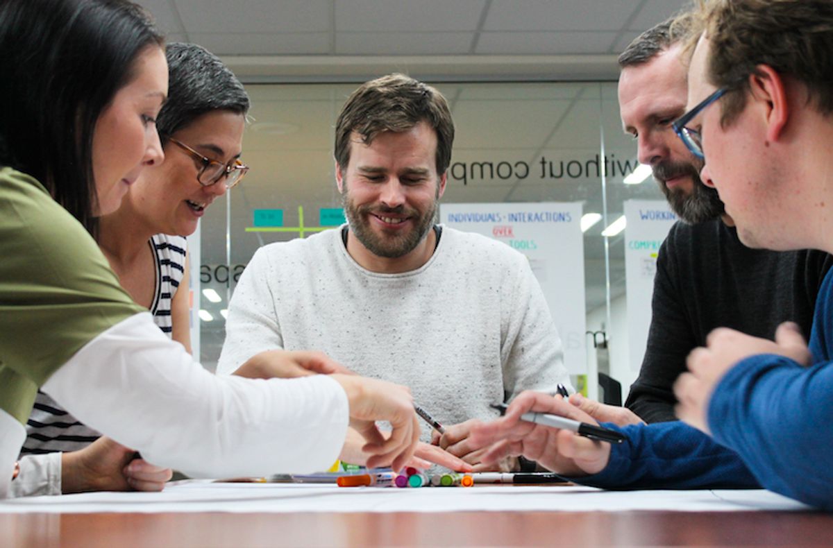 A team meet to clarify what goes in their definition of done and acceptance criteria.