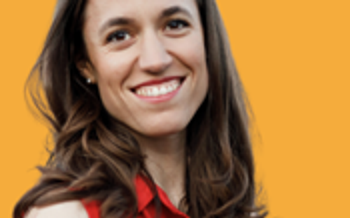 Romina Maillochaud, Chief of Experience at Comet, smiling against an orange background.