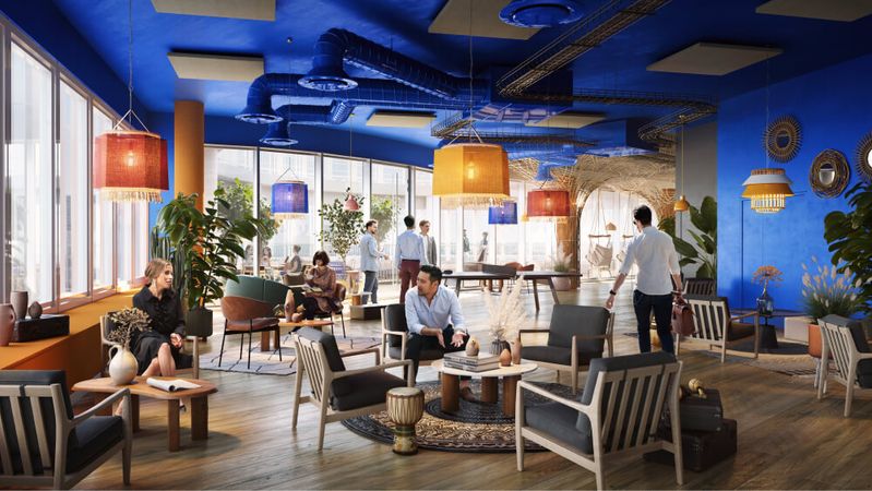 A lounge with deep blue walls and ceiling, furnished with wooden armchairs and colourful wicker pendant lamps, where colleagues chat among the plants.