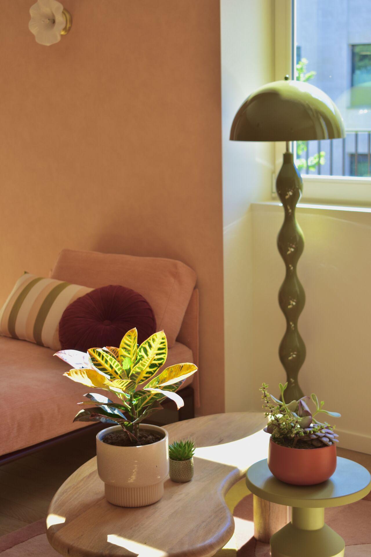 Terracotta-toned lounge area with a brass lamp and low tables