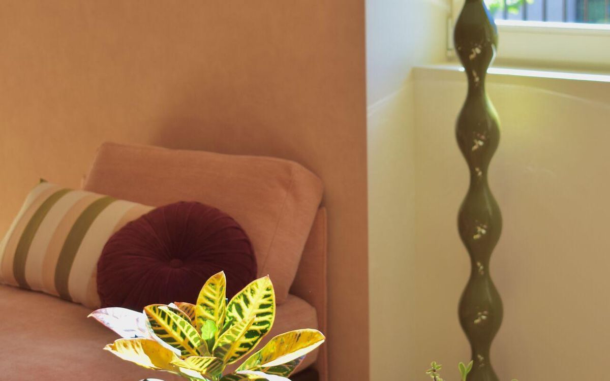 Terracotta-toned lounge area with a brass lamp and low tables
