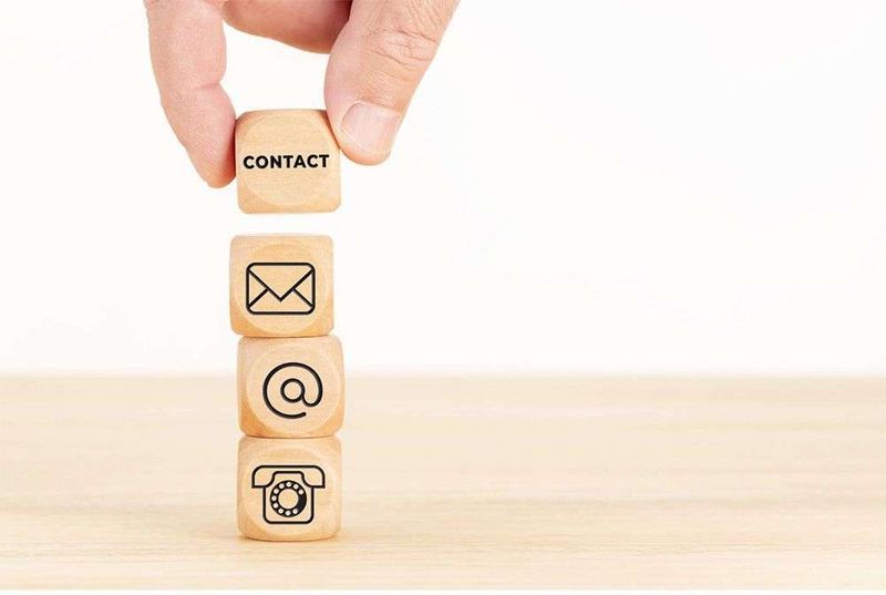 A stack of cubes with contact related icons on each representing a Contact Management System