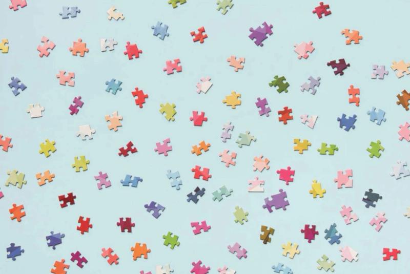 Scattered puzzle pieces representing fragmented contacts.