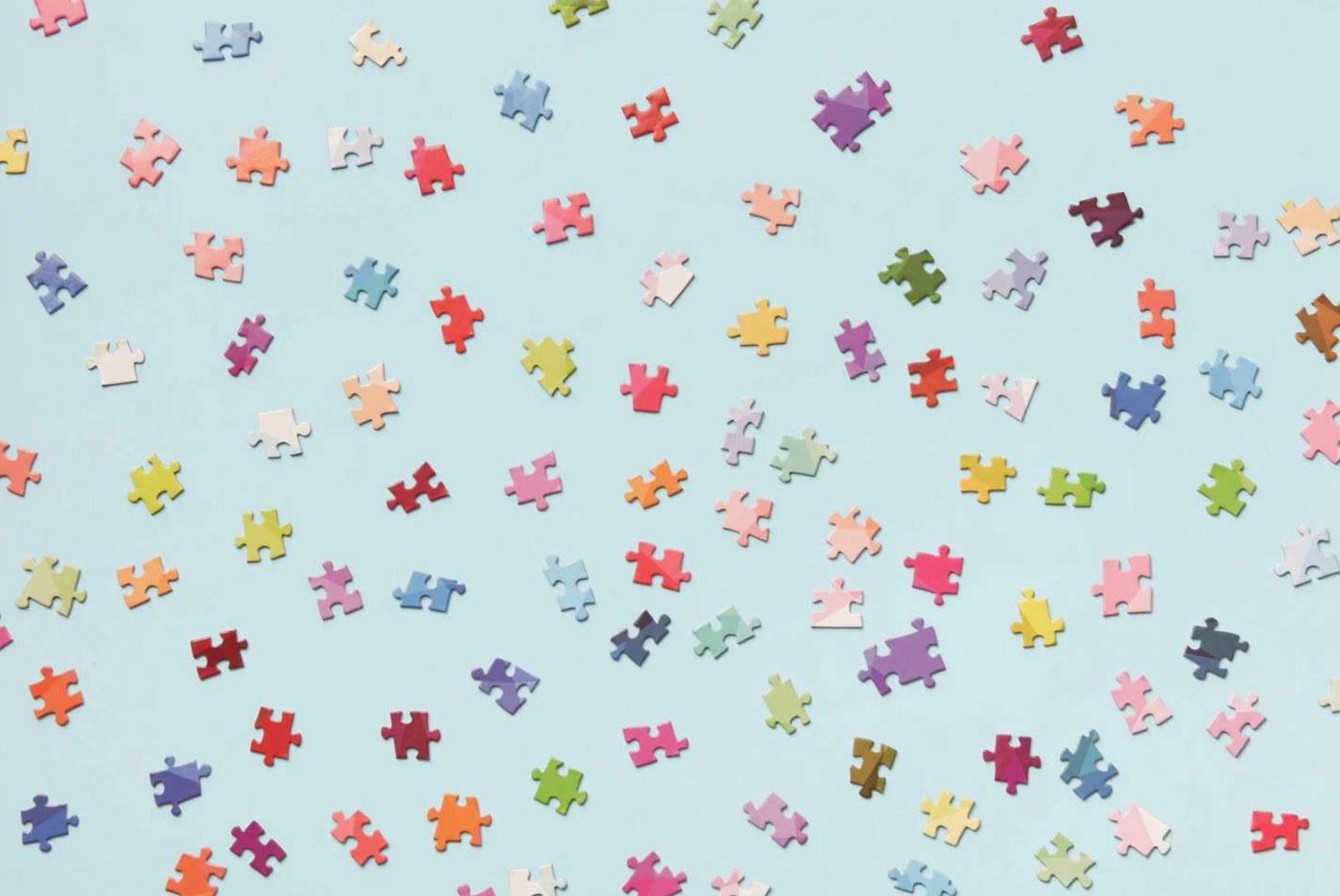 Scattered puzzle pieces representing fragmented contacts.