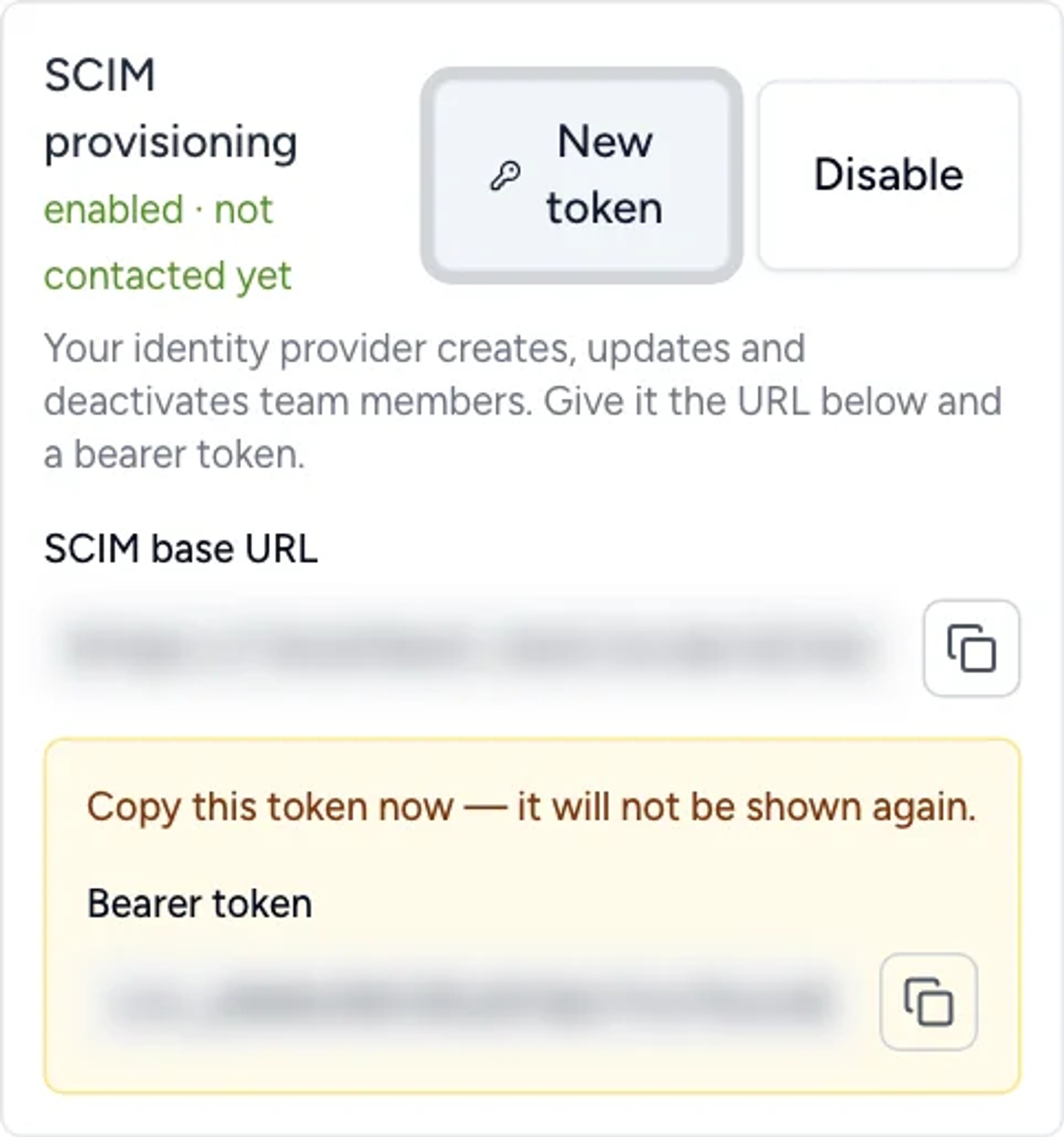 SCIM provisioning panel showing the New token button, the SCIM base URL and a bearer token shown once; values blurred.