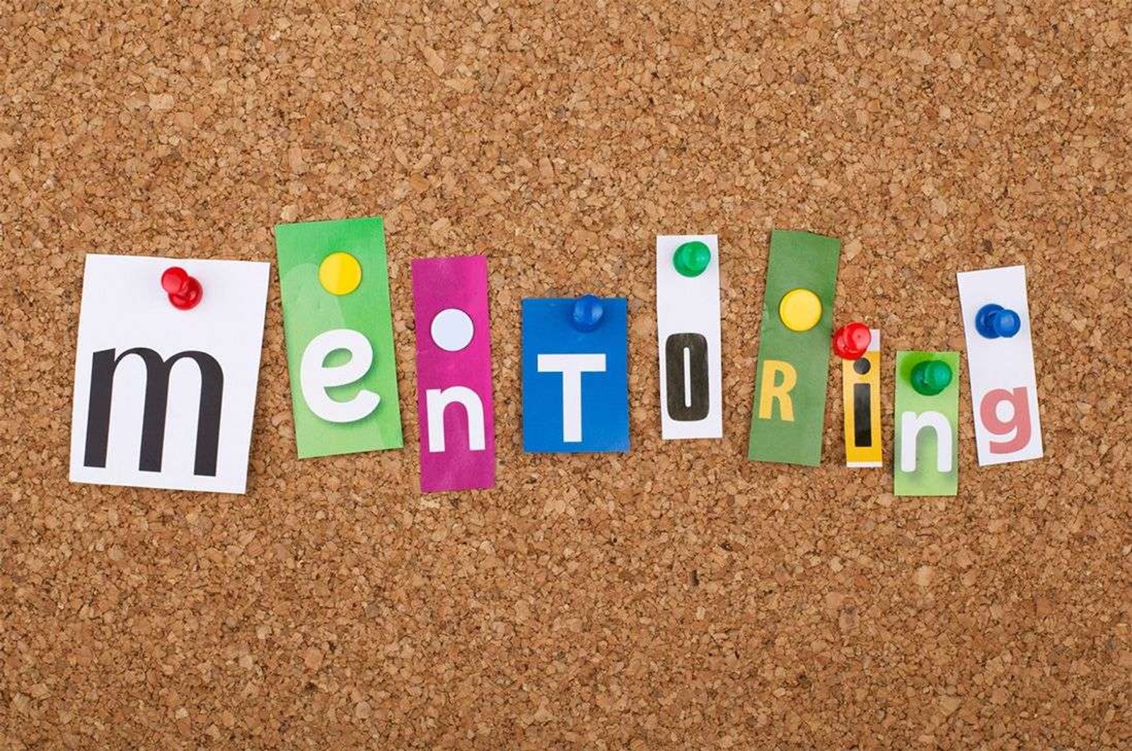 The word mentoring spelled out with paper notes.