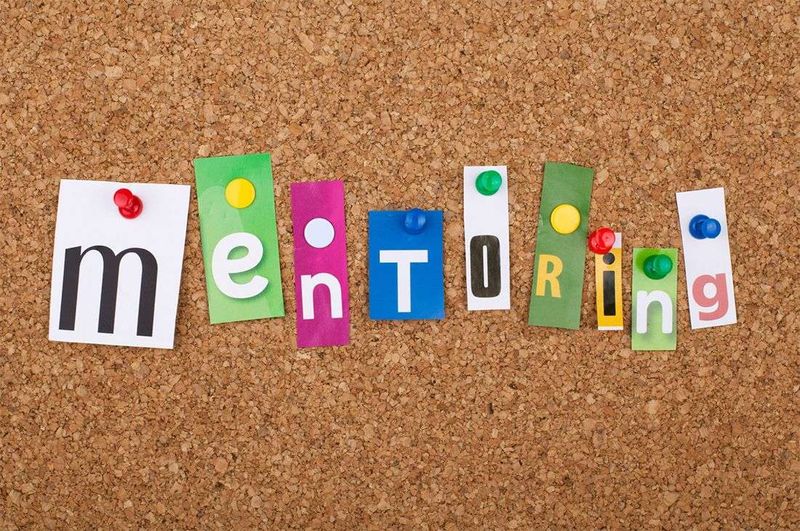 The word mentoring spelled out with paper notes.