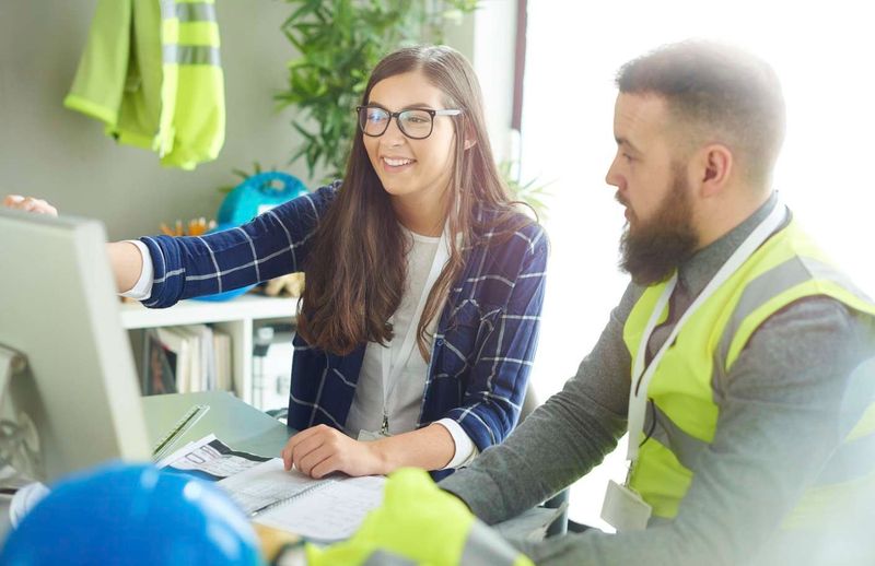 Office and Field team members liaising over designs on a desktop computer.