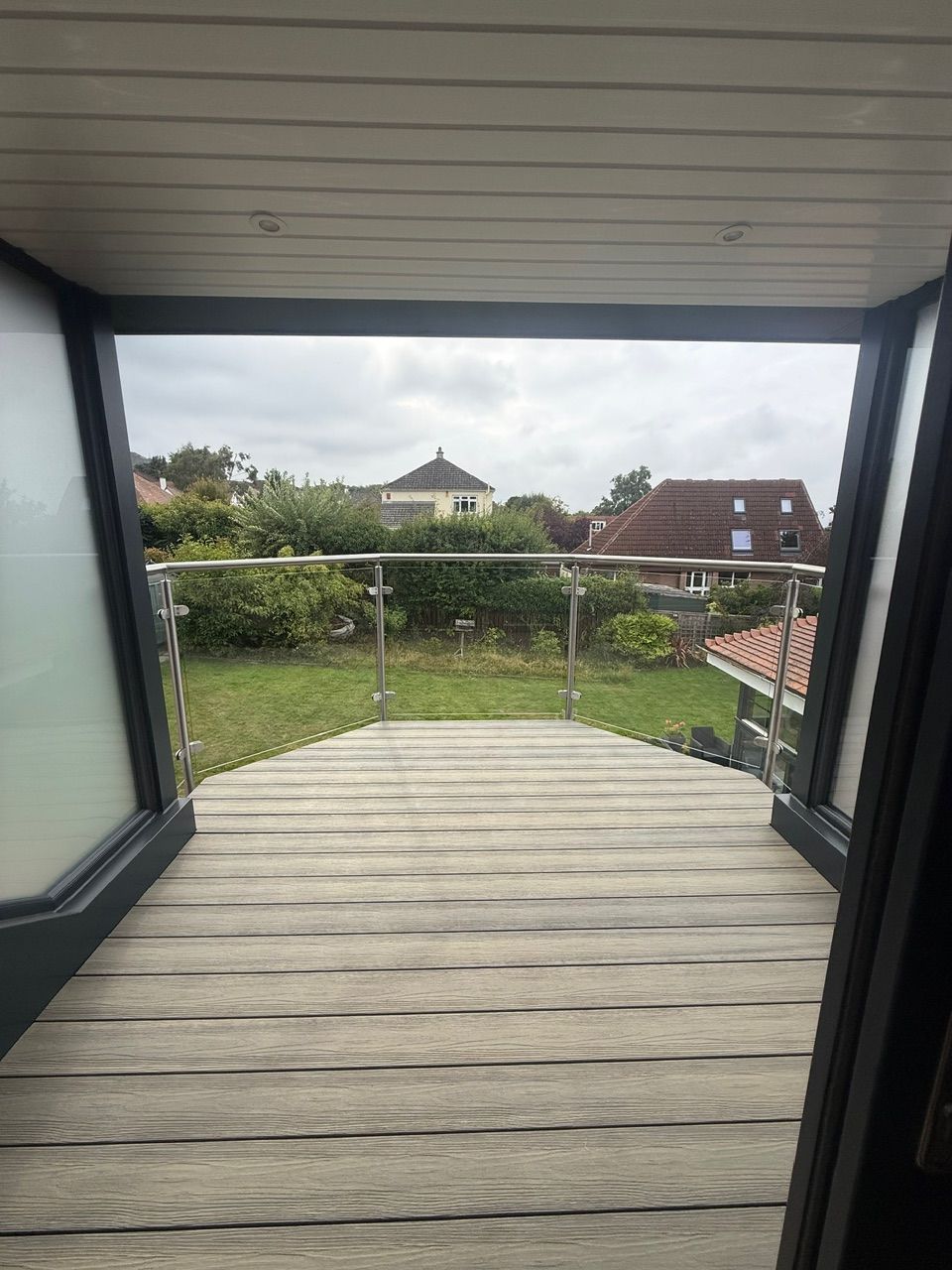 Covered balcony and glass balustrade overlooking the garden at Fernielaw Avenue