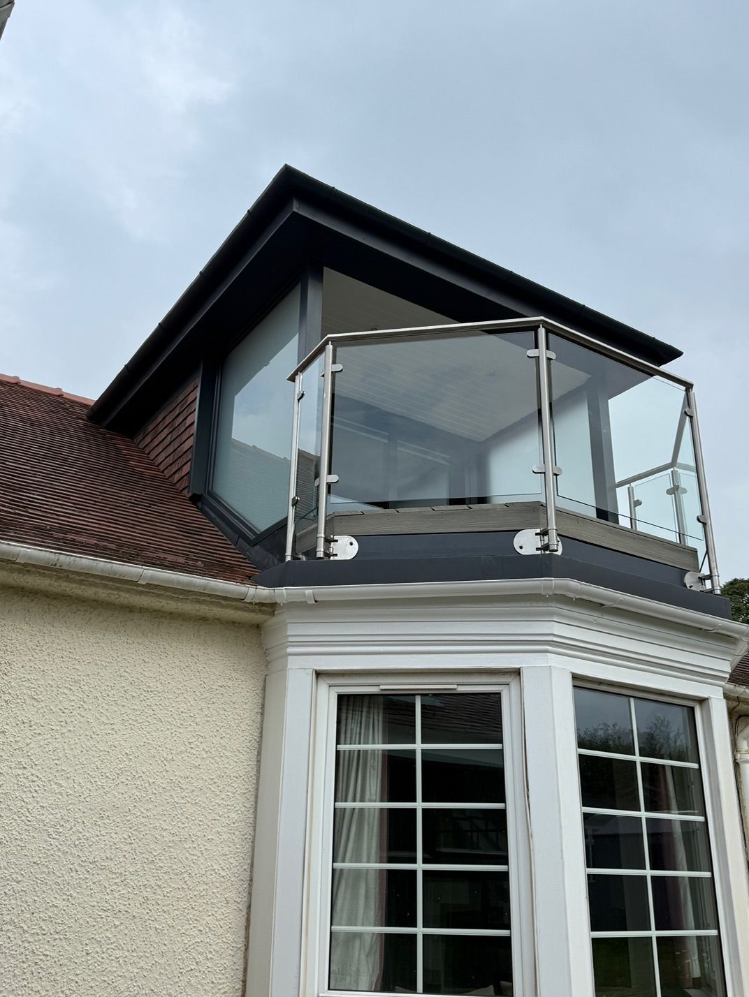 Angled exterior view of the dormer and glass balcony at Fernielaw Avenue