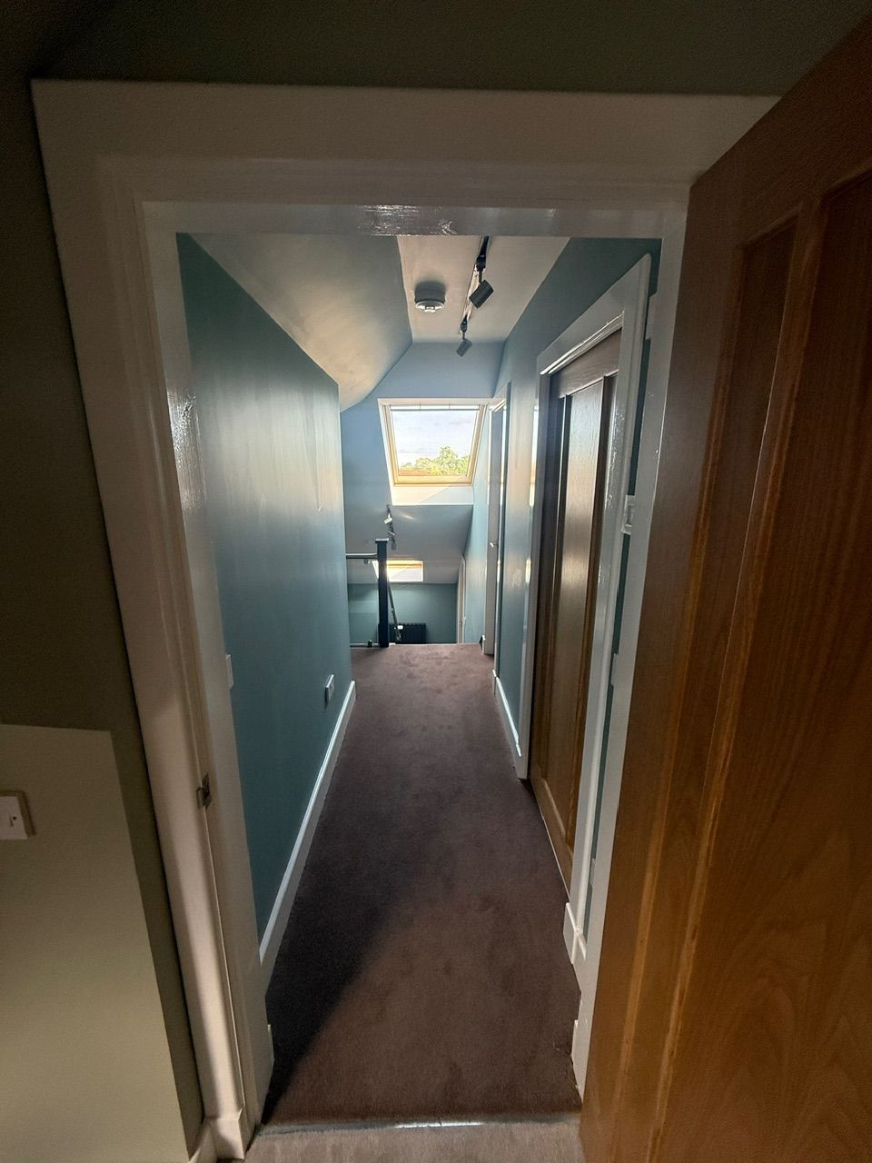Decorated upper-floor hallway with timber doors at Fernielaw Avenue