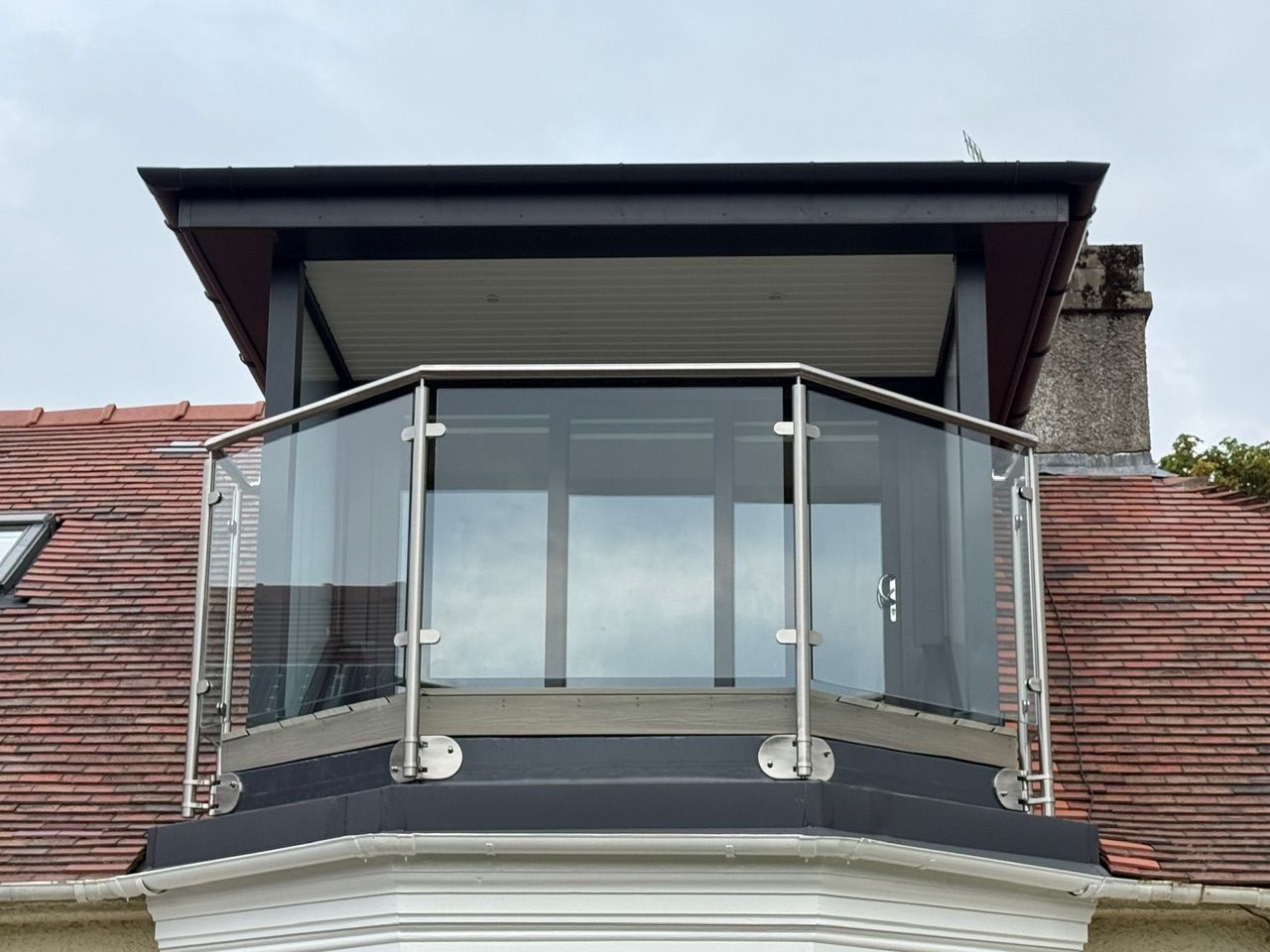 Completed dormer with sheltered balcony and glass balustrade at Fernielaw Avenue