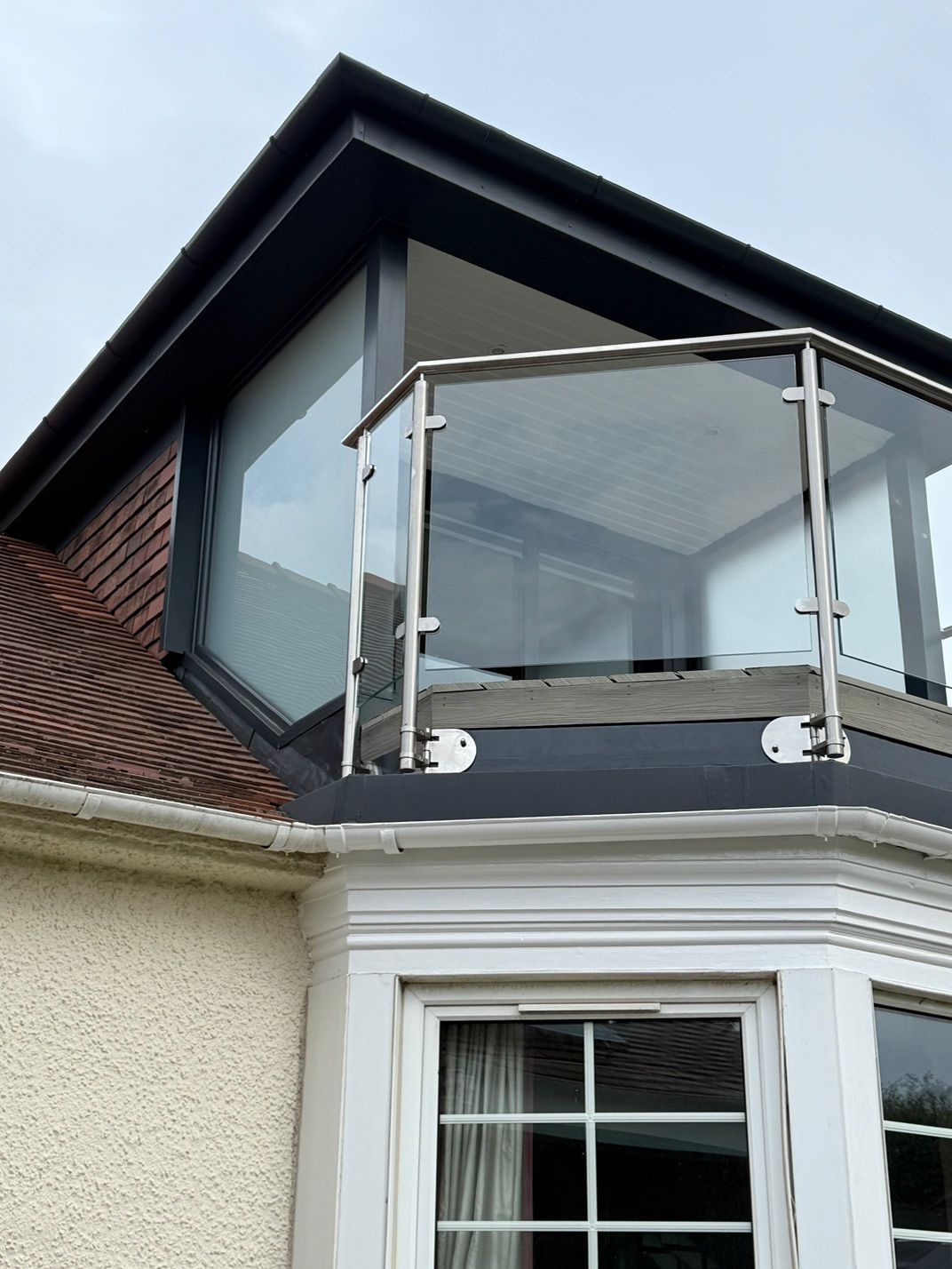 Glass balustrade and dark cladding on the completed dormer at Fernielaw Avenue