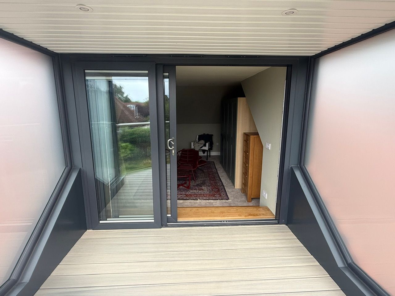 View across the balcony decking towards the open patio doors at Fernielaw Avenue