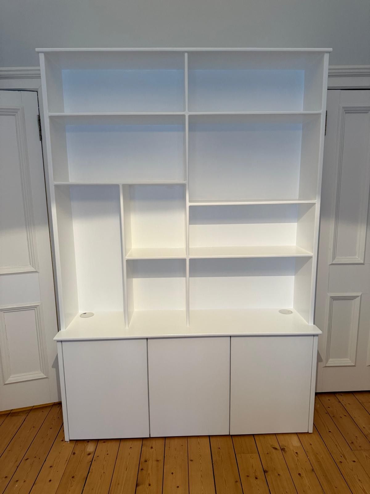 Bespoke white shelving unit shown between existing internal doors