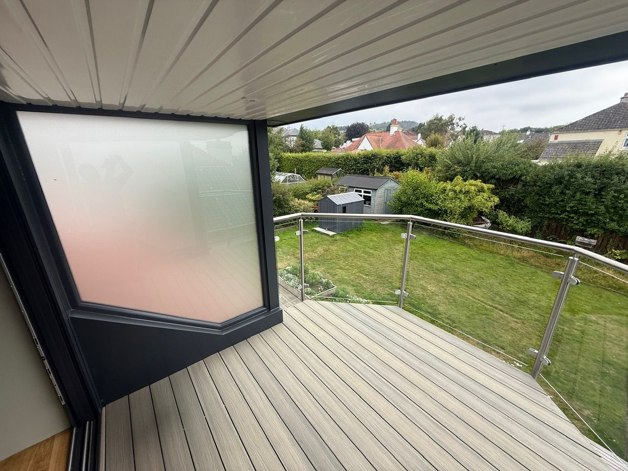 Balcony decking and glass balustrade overlooking neighbouring gardens at Fernielaw Avenue