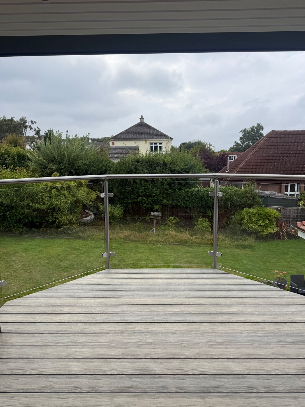 Garden view over the balcony decking and glass balustrade at Fernielaw Avenue