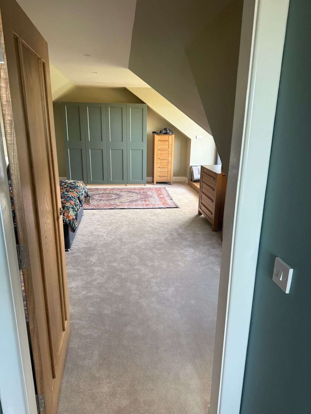 View into the completed loft bedroom with fitted storage at Fernielaw Avenue
