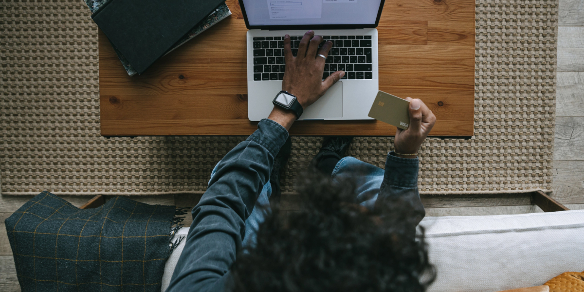 man paying with card at home after receiving a reminder to pay
