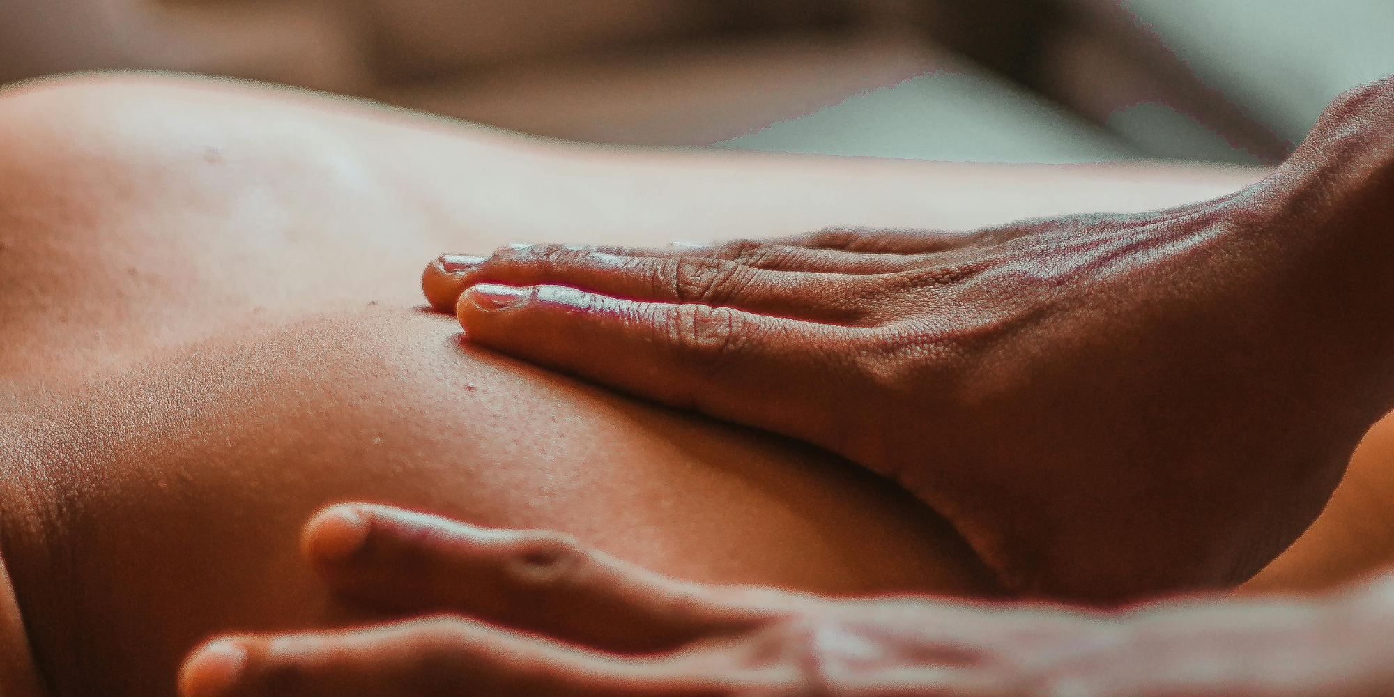 Close-up of hands massaging a client’s back