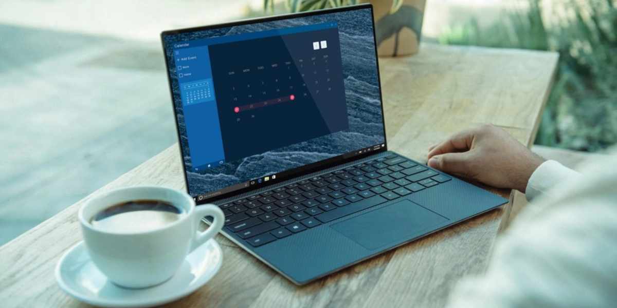 Personne regardant un calendrier sur un ordinateur portable avec un logiciel de planification qui s’intègre à Outlook, avec une tasse de café sur le bureau