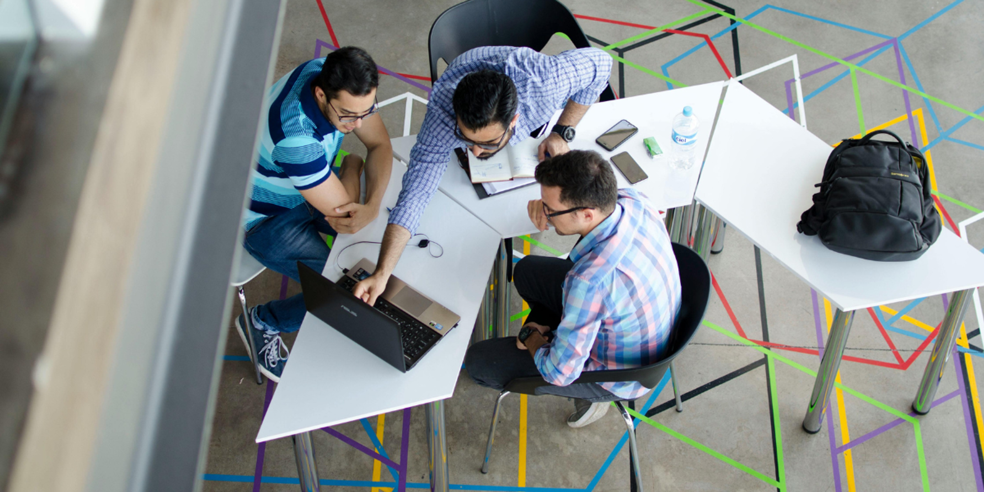 Three male colleagues in a meeting following effective meeting techniques