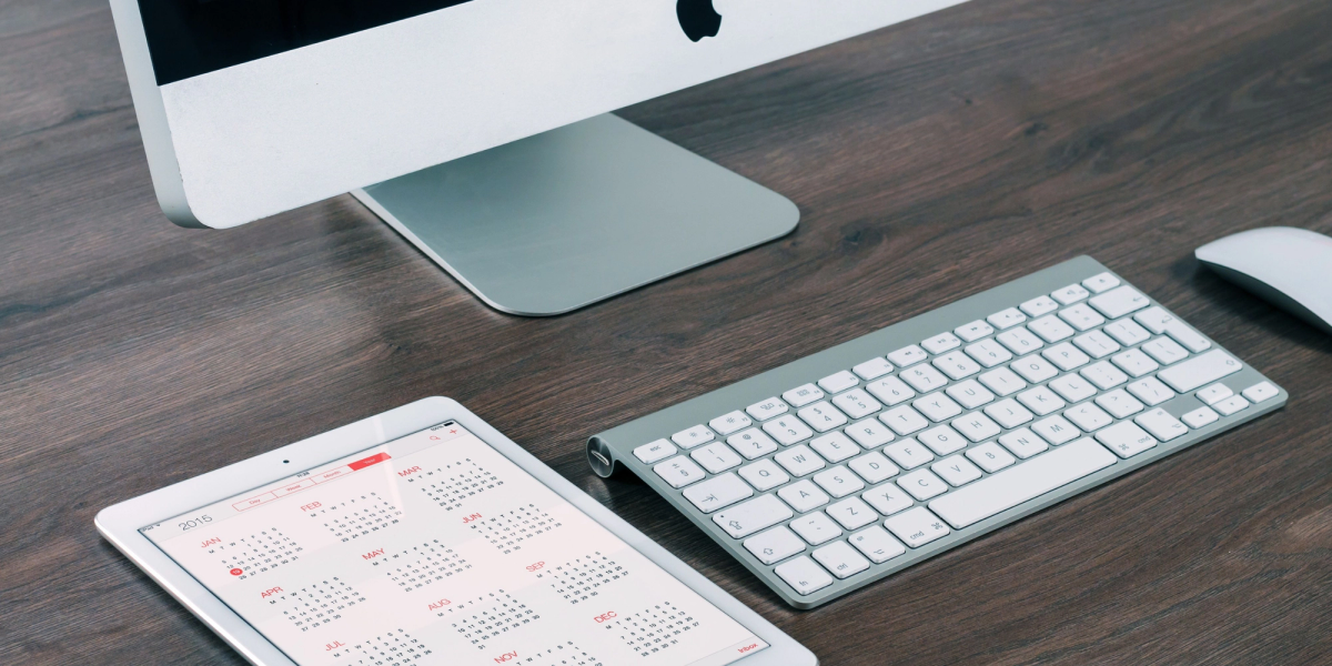 apple devices on a dark table during sync google calendar with apple calendar